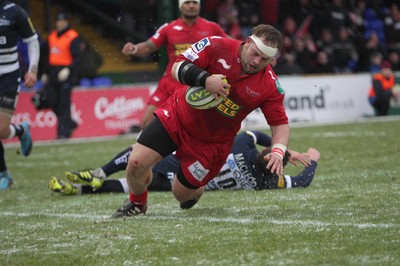 04.02.12 - Sale Sharks v Scarlets - LV= Cup.Peter Edwards of Scarlets shrugs off a tackle from Sale's Nick Macloed to score the Scarlets' first try..