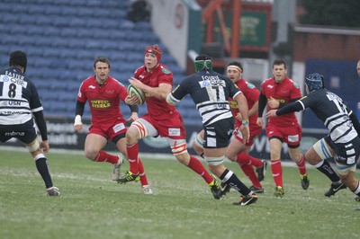 04.02.12 - Sale Sharks v Scarlets - LV= Cup.Scarlets' Kieran Murphy takes on Sale's Hendre Fourie..