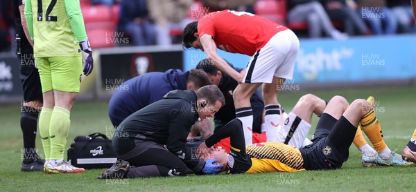 040323 - Salford City v Newport County - Sky Bet League 2 - Matt Baker of Newport County and Conor McAleny of Salford City are treated for concussion 