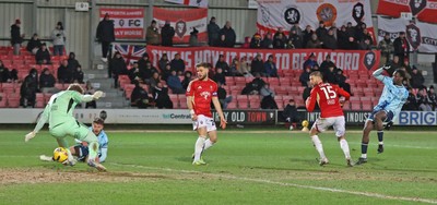 170226 - Salford City v Newport County - Sky Bet League 2 - Nathan Opoku of Newport shoots the ball through the legs of Goalkeeper Matthew Young of Salford for Newport’s 3rd goal