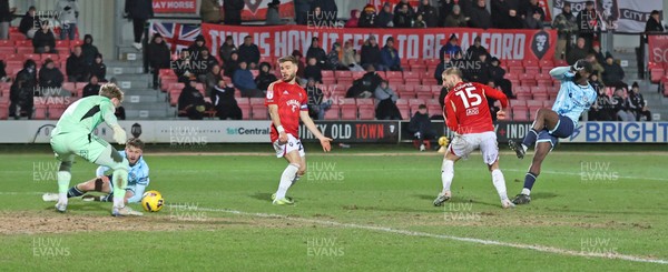 170226 - Salford City v Newport County - Sky Bet League 2 - Nathan Opoku of Newport shoots the ball through the legs of Goalkeeper Matthew Young of Salford for Newport’s 3rd goal