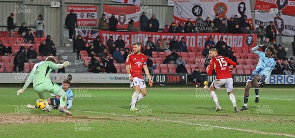 170226 - Salford City v Newport County - Sky Bet League 2 - Nathan Opoku of Newport shoots the ball through the legs of Goalkeeper Matthew Young of Salford for Newport’s 3rd goal