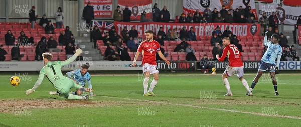 170226 - Salford City v Newport County - Sky Bet League 2 - Nathan Opoku of Newport shoots the ball through the legs of Goalkeeper Matthew Young of Salford for Newport’s 3rd goal