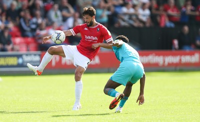 280821 - Salford City v Newport County, Sky Bet League 2 - Jason Lowe of Salford City plays the ball over Timmy Abraham of Newport County