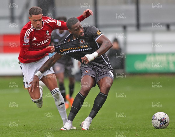 300923 - Salford City v Newport County - Sky Bet League 2 - Omar Bogle of Newport County is held by Ethan Ingram of Salford City 