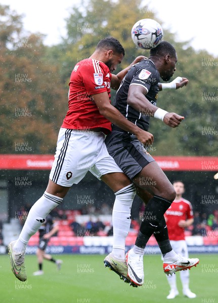 300923 - Salford City v Newport County - Sky Bet League 2 - Omar Bogle of Newport County and Adrian Mariappa of Salford City head the long high ball