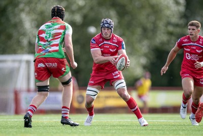 060925 - Scarlets Preseason Friendlies - Scarlets play preseason friendlies v Regional SRC Clubs Llandovery RFC and Carmarthen Quins RFC - Tristan Davies of Scarlets runs at Dylan Alford of Llandovery  