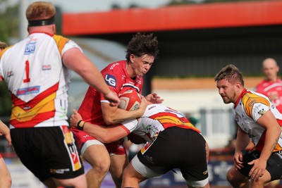 060925 - Scarlets Preseason Friendlies - Scarlets play preseason friendlies v Regional SRC Clubs Llandovery RFC and Carmarthen Quins RFC - Gabe Mcdonald of Scarlets is stopped by Lewis Morgan of Carmarthen Quins    
