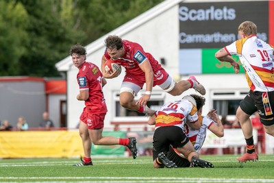 060925 - Scarlets Preseason Friendlies - Scarlets play preseason friendlies v Regional SRC Clubs Llandovery RFC and Carmarthen Quins RFC - Dom Kossuth of Scarlets is upended by two Quins defenders       
