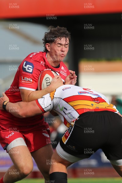 060925 - Scarlets Preseason Friendlies - Scarlets play preseason friendlies v Regional SRC Clubs Llandovery RFC and Carmarthen Quins RFC - Gabe Mcdonald of Scarlets is stopped by Lewis Morgan of Carmarthen Quins  