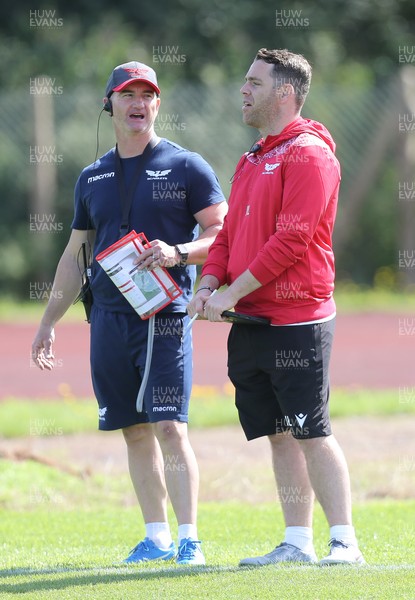 240821 - Scarlets Training session - Scarlets head of physical performance Nigel Ashley-Jones, left with Head of Technical Performance Joe Lewis during training session