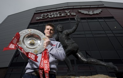 280212 - Scarlets Triple Crown Photocall -Scott Williams of Wales and Scarlets with the triple crown next to the Ray Gravell statue outside Parc y Scarlets