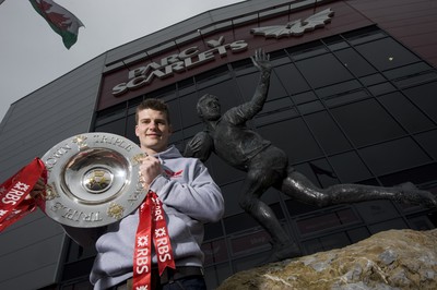 280212 - Scarlets Triple Crown Photocall -Scott Williams of Wales and Scarlets with the triple crown next to the Ray Gravell statue outside Parc y Scarlets