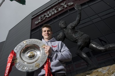 280212 - Scarlets Triple Crown Photocall -Scott Williams of Wales and Scarlets with the triple crown next to the Ray Gravell statue outside Parc y Scarlets