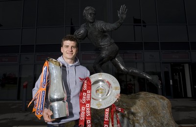 280212 - Scarlets Triple Crown Photocall -Scott Williams of Wales and Scarlets with the triple crown and RaboDirect trophy next to the Ray Gravell statue outside Parc y Scarlets