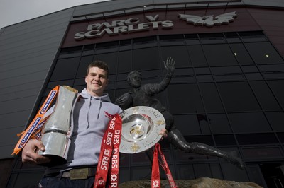 280212 - Scarlets Triple Crown Photocall -Scott Williams of Wales and Scarlets with the triple crown and RaboDirect trophy next to the Ray Gravell statue outside Parc y Scarlets