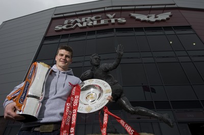 280212 - Scarlets Triple Crown Photocall -Scott Williams of Wales and Scarlets with the triple crown and RaboDirect trophy next to the Ray Gravell statue outside Parc y Scarlets