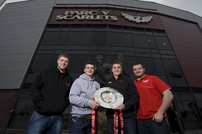 280212 - Scarlets Triple Crown Photocall -Rhys Priestland, Scott Williams, Jonathan Davies and Ken Owens of Wales and Scarlets with the triple crown next to the Ray Gravell statue outside Parc y Scarlets