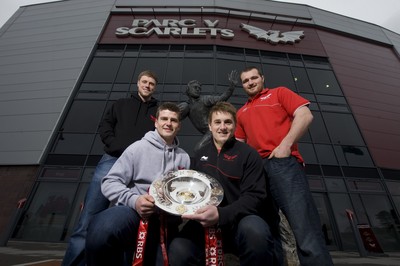 280212 - Scarlets Triple Crown Photocall -Rhys Priestland, Scott Williams, Jonathan Davies and Ken Owens of Wales and Scarlets with the triple crown next to the Ray Gravell statue outside Parc y Scarlets