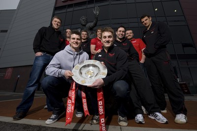 280212 - Scarlets Triple Crown Photocall -Rhys Priestland, Lou Reed, Scott Williams, Rhodri Jones, Liam Williams, Jonathan Davies, Stephen Jones, Ken Owens and Aaron Shingler of Wales and Scarlets with the triple crown next to the Ray Gravell statue outside Parc y Scarlets