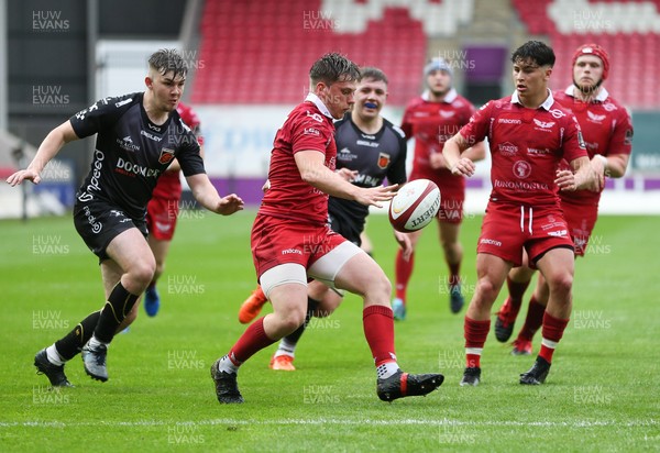 090621 - Scarlets U18 v Dragons U18 - Ollie Fish of Scarlets kicks clear as Kyle Collins-Smith of Dragons closes in