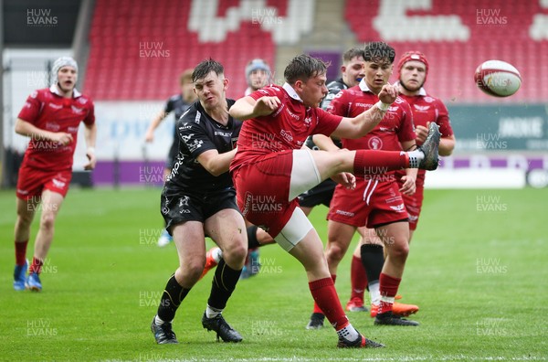 090621 - Scarlets U18 v Dragons U18 - Ollie Fish of Scarlets kicks clear as Kyle Collins-Smith of Dragons closes in