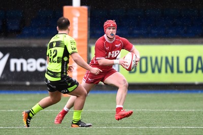 230225 - Scarlets U18s v Dragons U18s - Regional Age-Grade Championship finals - Osian Williams of Scarlets U18s is challenged by David Petrescu of Dragons U18s