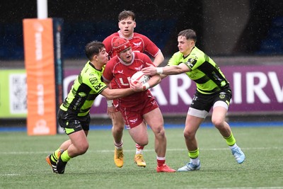 230225 - Scarlets U18s v Dragons U18s - Regional Age-Grade Championship finals - Osian Williams of Scarlets U18s is challenged by David Petrescu and Rhys Cole of Dragons U18s