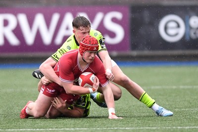 230225 - Scarlets U18s v Dragons U18s - Regional Age-Grade Championship finals - Osian Williams of Scarlets U18s is challenged by Rhys Cole of Dragons U18s