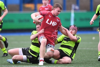 230225 - Scarlets U18s v Dragons U18s - Regional Age-Grade Championship finals - Kai Jones of Scarlets U18s is brought down