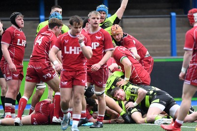 230225 - Scarlets U18s v Dragons U18s - Regional Age-Grade Championship finals - Carter Pritchard of Dragons U18s pushes the ball over to score a try