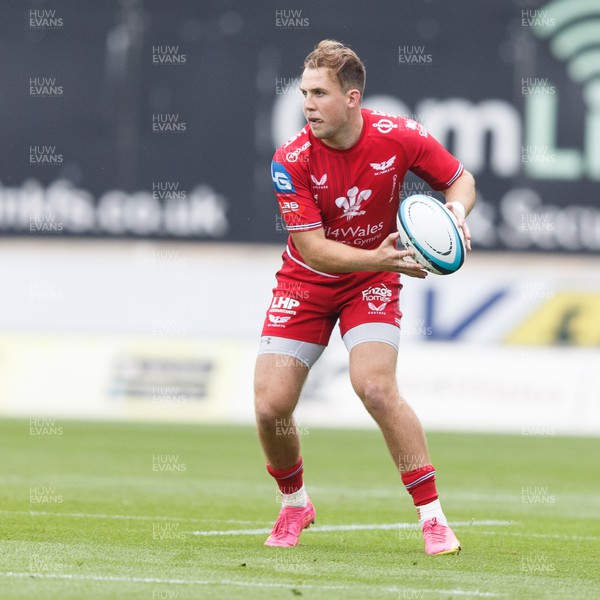 160923 - Scarlets v Barbarians - Phil Bennett Memorial Game - Ioan Lloyd of Scarlets looks for a gap