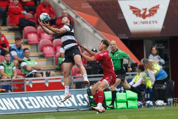 160923 - Scarlets v Barbarians - Phil Bennett Memorial Game - Dylan Pietsch of Barbarians takes a high ball under pressure from Tom Rogers of Scarlets