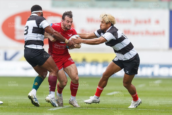 160923 - Scarlets v Barbarians - Phil Bennett Memorial Game - Ryan Conbeer of Scarlets is tackled by Filipo Daugunu and Ryohey Yamanaka of Barbarians