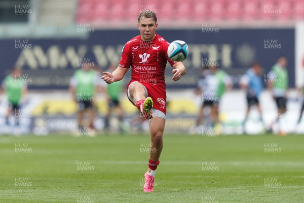 160923 - Scarlets v Barbarians - Phil Bennett Memorial Game - Ioan Lloyd of Scarlets kicks for touch