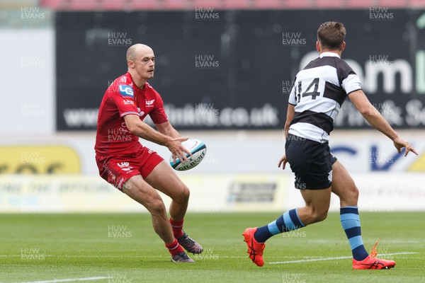 160923 - Scarlets v Barbarians - Phil Bennett Memorial Game - Ioan Nicholas of Scarlets passes the ball