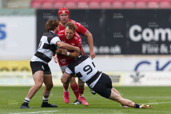 160923 - Scarlets v Barbarians - Phil Bennett Memorial Game - Ioan Lloyd of Scarlets is tackled by James O’Connor and Ryan Lonergan of Barbarians