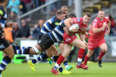 200816 - Scarlets v Bath - Preseason Friendly -Gareth Davies of Scarlets is tackled by Taulupe Faletau of Bath