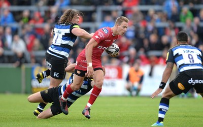 200816 - Scarlets v Bath - Preseason Friendly -Liam Williams of Scarlets is tackled by Rhys Priestland of Bath