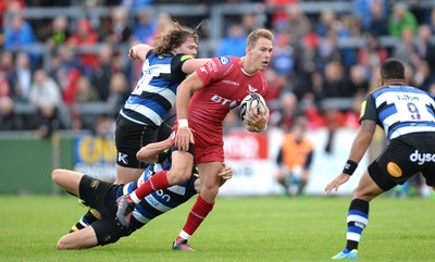 200816 - Scarlets v Bath - Preseason Friendly -Liam Williams of Scarlets is tackled by Rhys Priestland of Bath