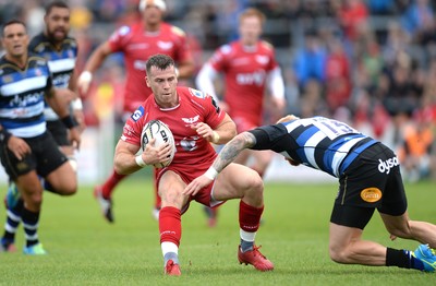 200816 - Scarlets v Bath - Preseason Friendly -Gareth Davies of Scarlets is tackled by Tom Homer of Bath