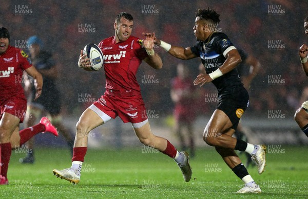 201017 - Scarlets v Bath - European Rugby Champions Cup - Gareth Davies of Scarlets is tackled by Anthony Watson of Bath as he races towards the line