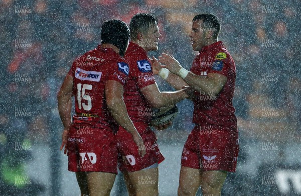 201017 - Scarlets v Bath - European Rugby Champions Cup - Steff Evans of Scarlets celebrates scoring a try with Leigh Halfpenny and Gareth Davies