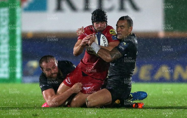 201017 - Scarlets v Bath - European Rugby Champions Cup - Leigh Halfpenny of Scarlets is tackled by Tom Dunn and Kahn Fotuali'i of Bath