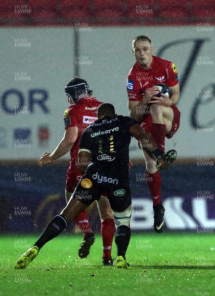 201017 - Scarlets v Bath - European Rugby Champions Cup - Johnny McNicholl of Scarlets is tackled in the air by Aled Brew of Bath