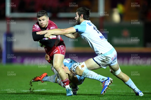 141219 - Scarlets v Bayonne - European Rugby Challenge Cup - Steff Evans of Scarlets is tackled by Arnaud Duputs and Bastien Bergounioux of Bayonne