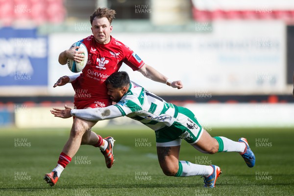 230324 - Scarlets v Benetton - United Rugby Championship - Ioan Lloyd of Scarlets is tackled by Onisi Ratave of Benetton