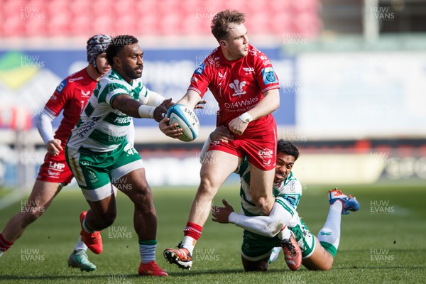 230324 - Scarlets v Benetton - United Rugby Championship - Ioan Lloyd of Scarlets is tackled by Onisi Ratave of Benetton