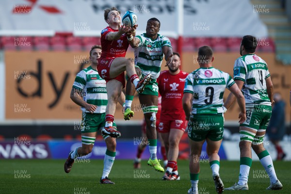 230324 - Scarlets v Benetton - United Rugby Championship - Tom Rogers of Scarlets goes up for a high ball with Onisi Ratave of Benetton