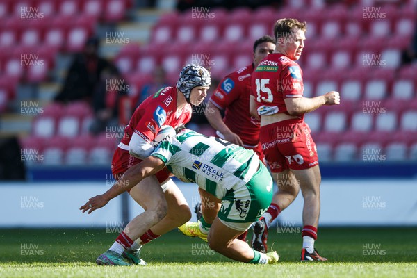 230324 - Scarlets v Benetton - United Rugby Championship - Tom Rogers of Scarlets is tackled by Siua Maile of Benetton